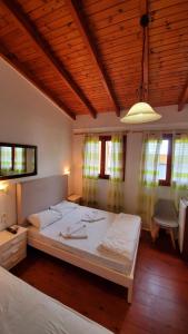 a bedroom with a large bed in a room with windows at Diporto in Chania