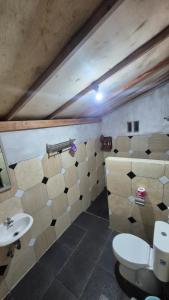 a bathroom with a toilet and a sink at Arsilahomestay in Tetebatu +25 photos