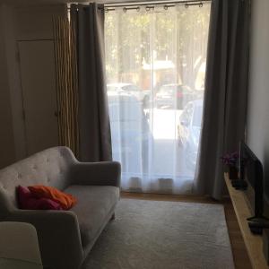 a living room with a couch and a window at Casa Pedra do Sal in Estoril