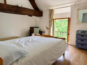 a bedroom with a white bed and a window at La Cahudiere in Saint-Martin-Landelles +56 photos