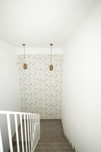 a hallway with white walls and a staircase with two lights at lovely cityscape in Lagos