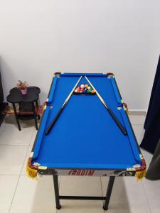 a blue pool table in a room at Yashz Guest House in Port Dickson