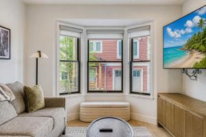 a living room with a couch and windows at Pet Friendly! Elevation 25 in Park City