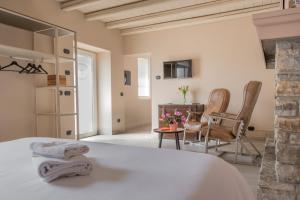 a bedroom with a bed and a table and chairs at Casale Raffaello B&B Como in Albese Con Cassano +43 photos