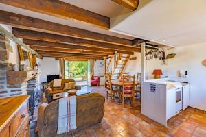 a living room with a kitchen and a dining room at La Cahudiere in Saint-Martin-Landelles