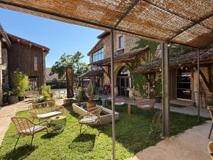 a patio with a bunch of chairs and tables at Art'Hotel & SPA Le Potin Gourmand in Cluny