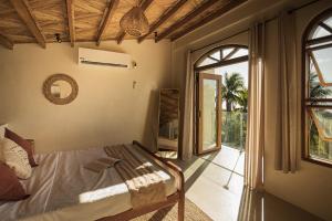 a bedroom with a bed and a sliding glass door at Native Villa with Pool at Kalumo Lodge in Oslob +37 photos