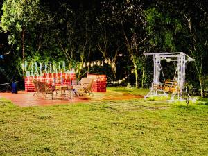 a patio with a table and chairs in a park at Elure Stays in Pātalpāni