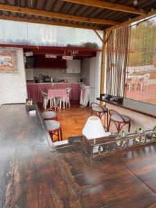 a room with a table and chairs and a counter at Finca El Escondite in Olocau