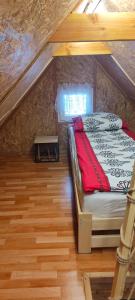 a bedroom with a bed in an attic at Domek MIŚ Na Stoku in Tylicz