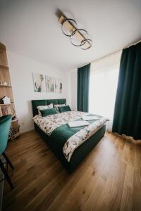 a bedroom with a bed and a large window at D Mol Studio apartman in Tuzla