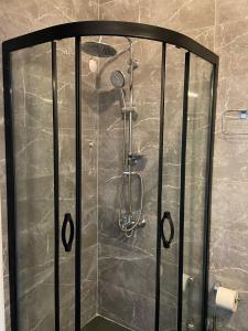 a shower with a glass door in a bathroom at Lilia Homes in Fethiye
