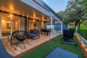 an outdoor deck with chairs and a table at ESTRADA MOBILE HoME in Biograd na Moru