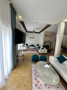 a living room with a couch and a table at Villa de prestige à Marrakech in Marrakesh