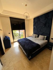 a bedroom with a large bed with a large stone wall at Villa de prestige à Marrakech in Marrakesh +21 photos
