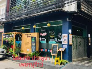 a blue building with a sign in front of it at Sleep cafe hidee247 in Pratunam
