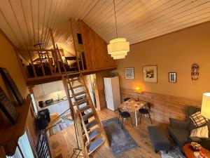 a living room with a ladder and a dining room at Daltorps skola - self check in in Skövde