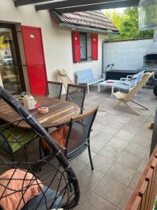 a patio with a table and chairs and a fire place at La Hiška Čatež with Tickets - each guest gets 2 entries per day in Čatež ob Savi