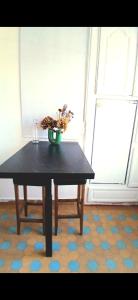 a table with a plant sitting on top of a floor at Cyrus House - maison complète 90m2 in Le Mans +4 photos