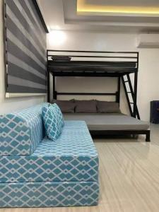 a bed sitting in a room with a bunk bed at A&E Transient Rooms in Calatagan