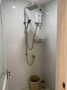 a shower in a bathroom with a toilet at A&E Transient Rooms in Calatagan +4 photos