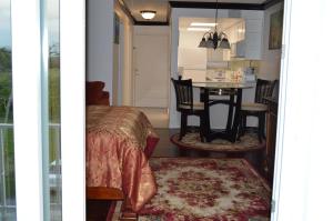 a room with a bed and a dining room with a table at Lakeview Studio Apartments On Golf Course in Freeport