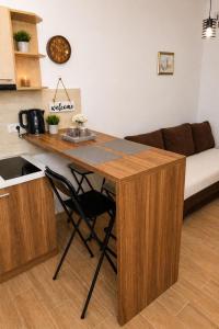 a kitchen with a desk and a couch in a room at Charm Apartment-Cathedral area-Self Check-in in Sarajevo +7 photos