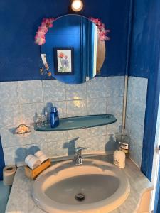 a bathroom with a sink and a mirror at 11 Steps Rustic Charming Flat in Normandy in Aubusson +19 photos