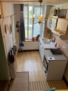 a small kitchen with a sink and a window at 11 Steps Rustic Charming Flat in Normandy in Aubusson