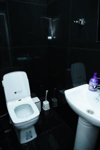 a black bathroom with a toilet and a sink at Casa Serena Sheki in Sheki +19 photos
