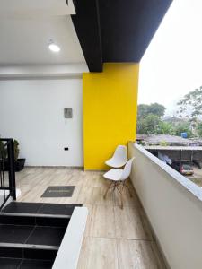 a white chair sitting on top of a building at Hotel Balcones in La Hormiga