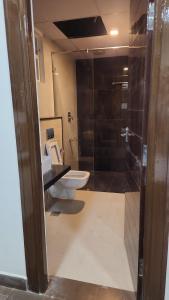a bathroom with a toilet and a sink and a shower at Holiday Home Madurai - Duplex Villa Umachikulam in Madurai +30 photos