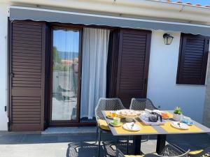 a table with a bowl of fruit on a patio at Apartman Luka in Pinezici