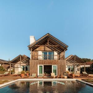 a house with a pool in front of it at Quinta Da Comporta - Wellness Boutique Resort in Comporta