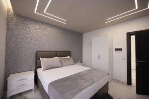 a bedroom with a bed and a white wall at Horizon Crown Rooms Ulcinj in Briska Gora +24 photos