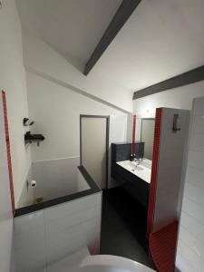 a white bathroom with a sink and a mirror at Maison de Village 4 chambres in Sabran +23 photos