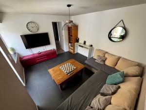 a living room with a couch and a table at Maison de Village 4 chambres in Sabran