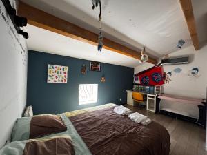 a bedroom with a bed and a desk in it at Maison de Village 4 chambres in Sabran