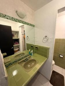 a bathroom with a sink and a mirror at Casita Escondida in Mérida +19 photos