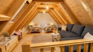 a living room with a couch and two beds at Rusínska chyža in Ulič