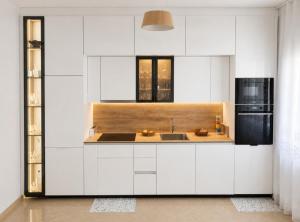 a white kitchen with a sink and a refrigerator at Sea View Borsh Albania in Borsh