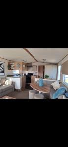 a living room with a couch and a table at Perranporth Cornwall in Perranporth