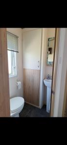 a small bathroom with a toilet and a sink at Perranporth Cornwall in Perranporth +16 photos