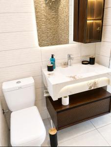 a bathroom with a toilet and a sink at Sea View Borsh Albania in Borsh