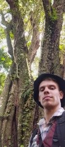 a man wearing a hat standing in front of a tree at RadiX MISIONES in Puerto Leoni