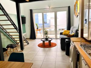 a living room with a couch and a table at Appartement 2 hyper centre d'Agen avec garage et terrasse in Agen +7 photos