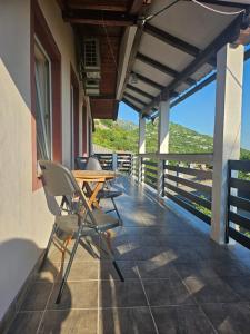 a patio with a table and chairs on a balcony at Ana & Stela in Karlobag