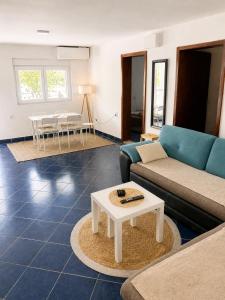 a living room with a couch and a table at VERIGE VIEW Kamenari in Donja Jošica +2 photos