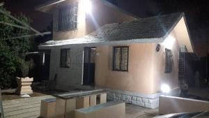 a small house is lit up at night at Neelprabha Farms in Karjat