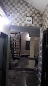 a view of a room with a staircase and a wall at Neelprabha Farms in Karjat
